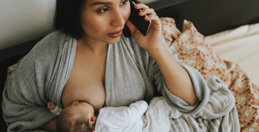mother-breastfeeding-while-on-the-phone-2021-08-27-00-05-27-utc